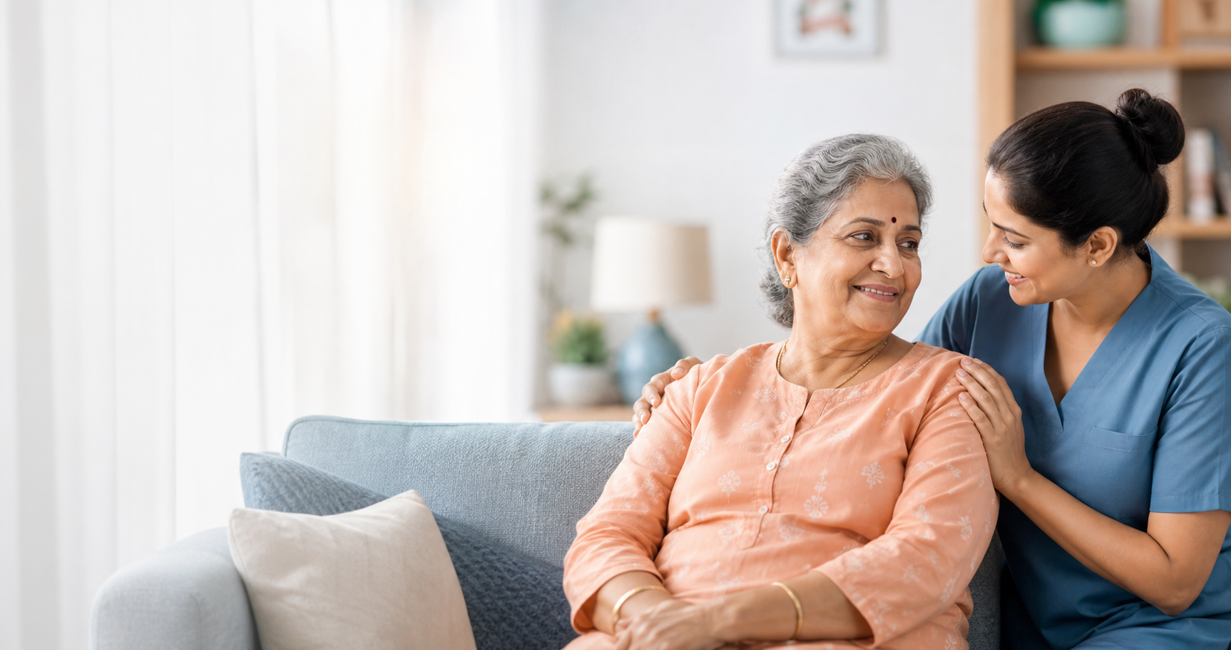 Elderly Indian woman at home with a reassuring caregiver